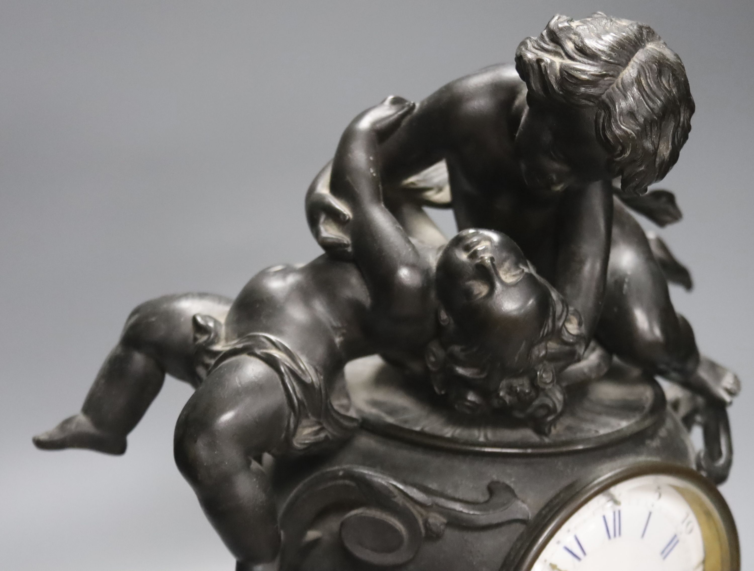 A Victorian spelter cherub mantel clock, height 39cm